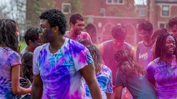 Students celebrate Holi with colored powders
