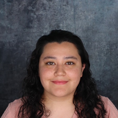 A woman smiles for a headshot