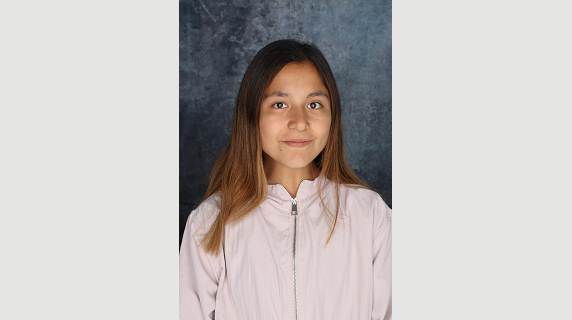 A woman smiles for a headshot