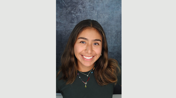 A woman smiles for a headshot