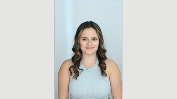 A woman smiles for a headshot