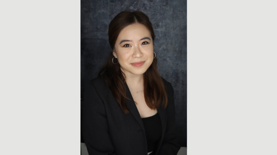 A woman smiles for a headshot