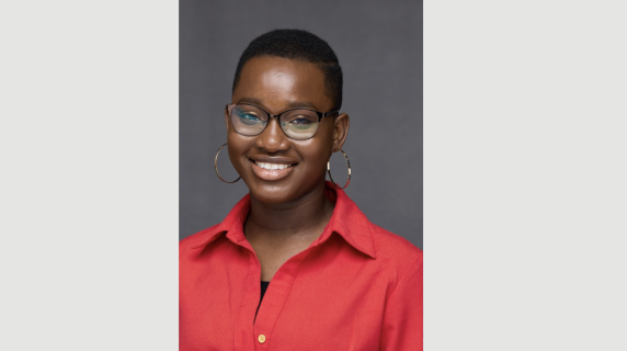 A woman smiles for a headshot