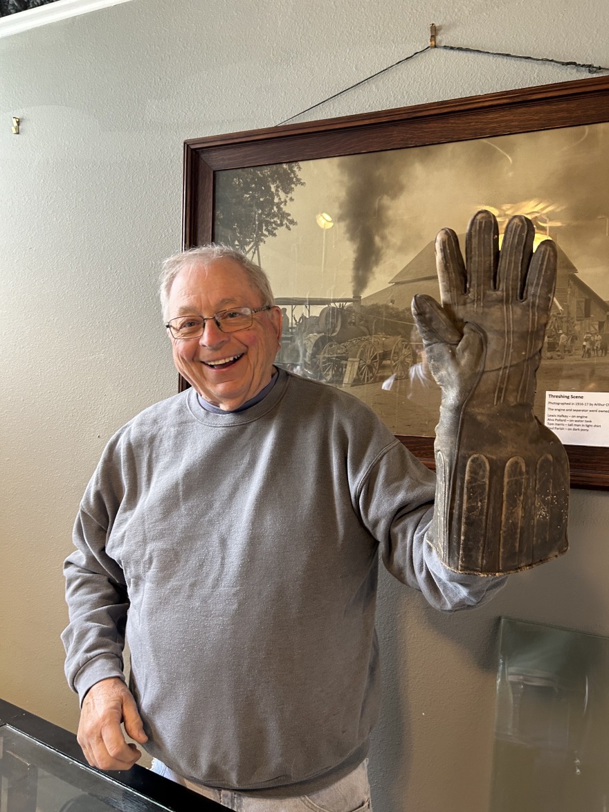 Frank Shults models one of the gauntlet gloves that were once manufactured in Grinnell.