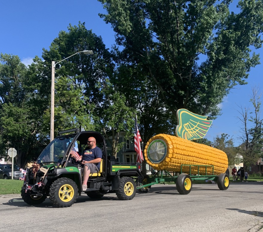 A four-wheeler pulls a huge ear of corn in a local parade