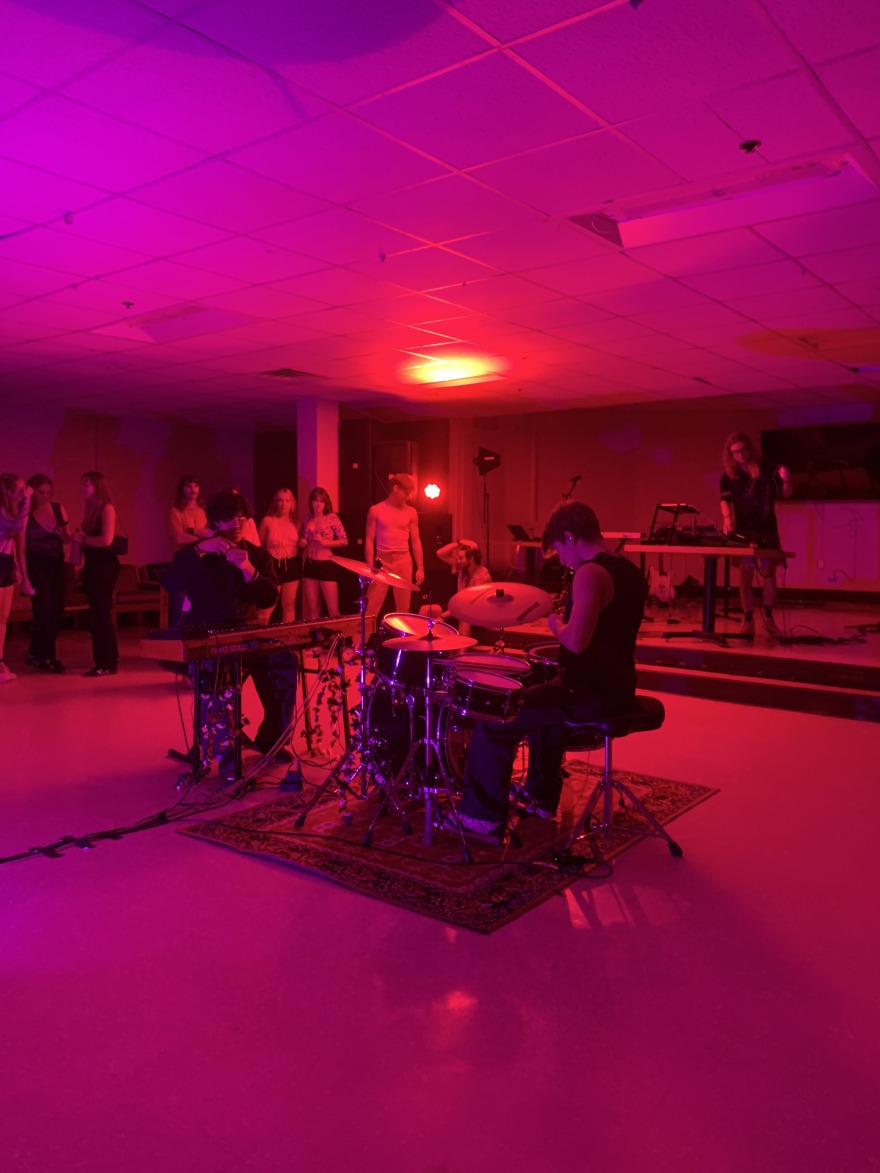 Musicians perform in Gardner Lounge under pink stagelights