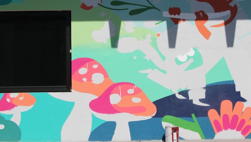 An incomplete mural piece of a nature landscape with two big mushrooms at the forefront.