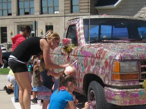 young people decorate a truck with glitter