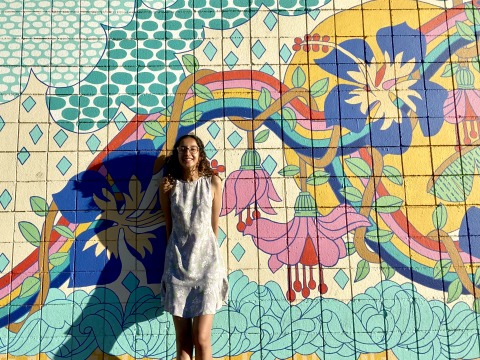 Jivyaa Vaidya standing in front of a colorful mural