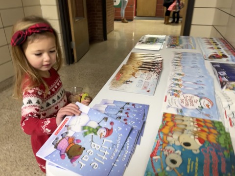 preschooler selects book 