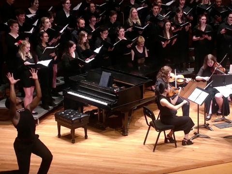 A dancer performs with the Grinnell Singers