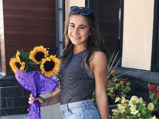 Student holding Sunflowers