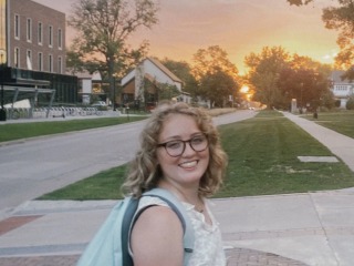 Me smiling at the camera with the sunset in the background