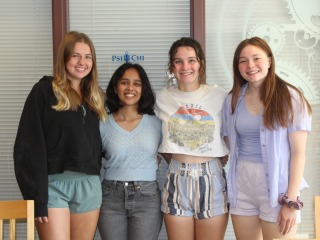 Nichole Henning, Saniya Kelkar, Elizabeth Clarkson, and Nikki Ware, in casual clothes, stand together