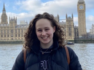 Ellen Hengesbach stands in front of Westminster Hall and Big Ben