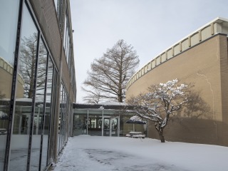 The snowy exterior of the Bucksbaum Center for the Arts