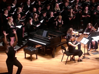 A dancer performs with the Grinnell Singers