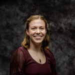 A woman smiles for a headshot