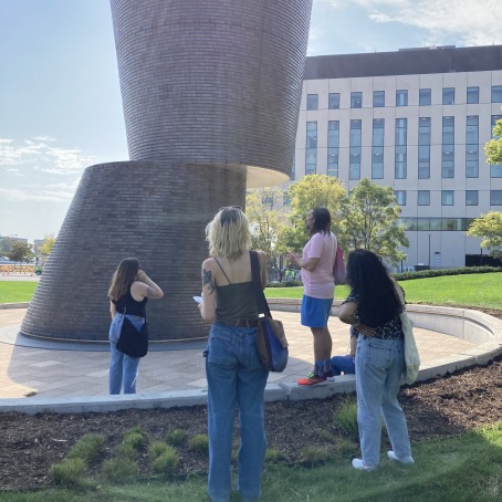 people standing looking at art in downtown des moines