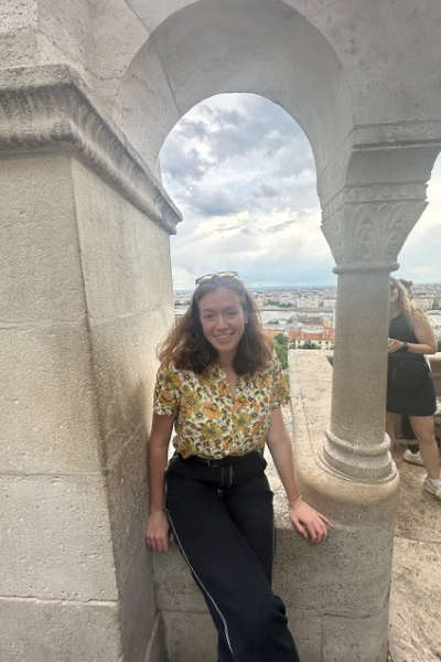 Sara poses in an archway